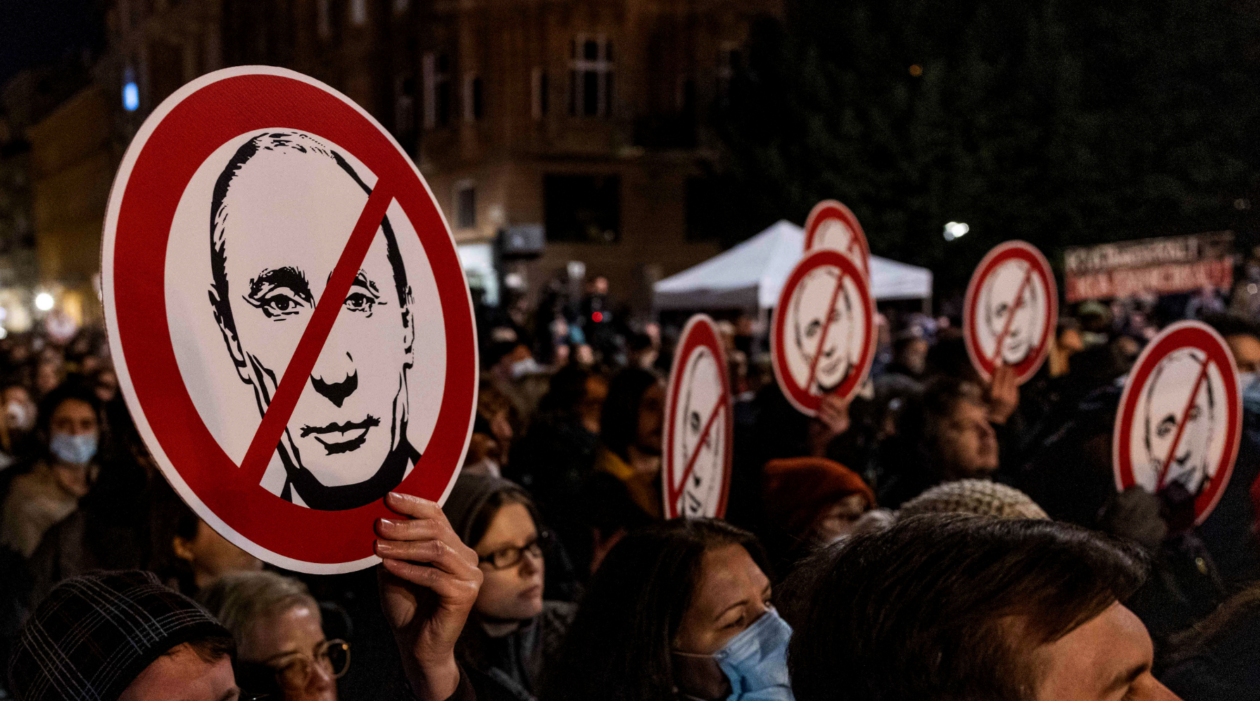 Protestors hold anti-Putin signs at a demostration