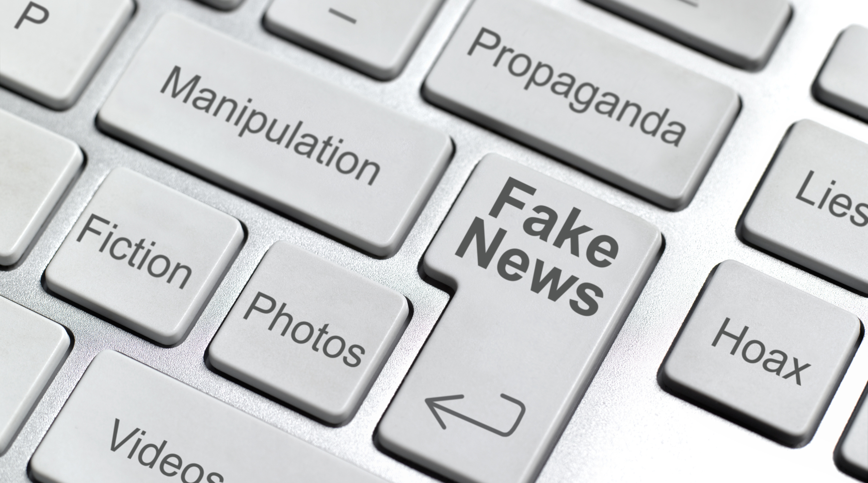 A keyboard displaying keys that read "Fake News," "Propaganda," "Manipulation," "Fiction," "Hoax," and "Lies."