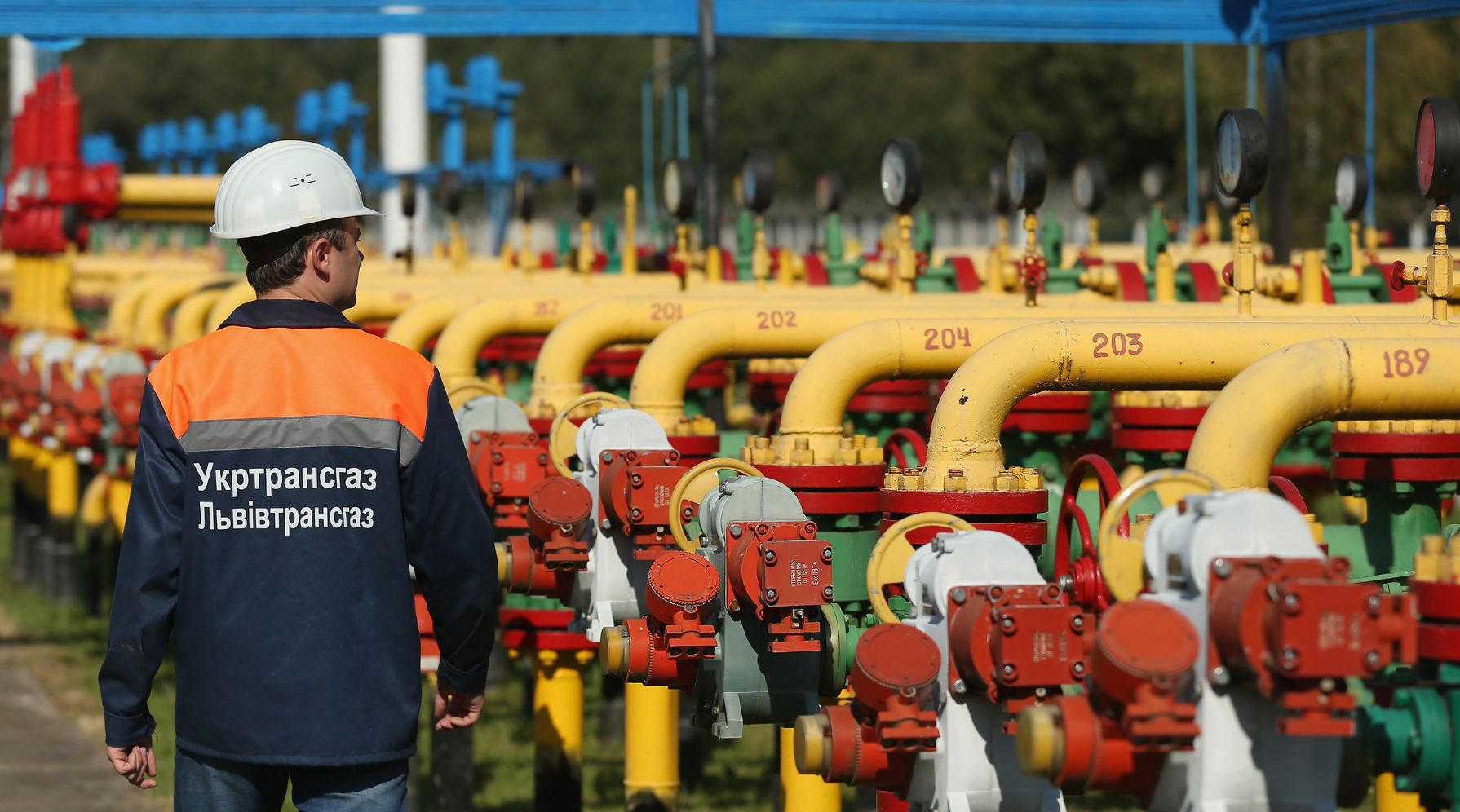 A worker walks among pipes and valves at a natural gas facility in the Dashava, Ukraine. 
